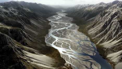 aerial view of a braided river flowing through a mountain valley