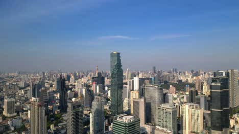 drone shot of mahanakhon tower in bangkok, silom area, business district, downtown