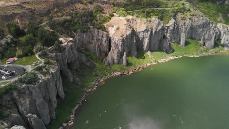 aerial upward tilt of the cliffs along the snake river and mist from shoshone falls in the foreground near twin falls, idaho