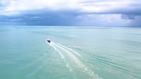 Aerial-tracking-shot-tracking-of-a-speedboat-travelling-through-the-tropical-ocean