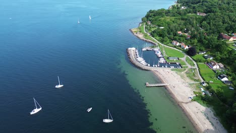 ven island, sweden: video of drone approaching the port of norreborg and the sandy beach nearby