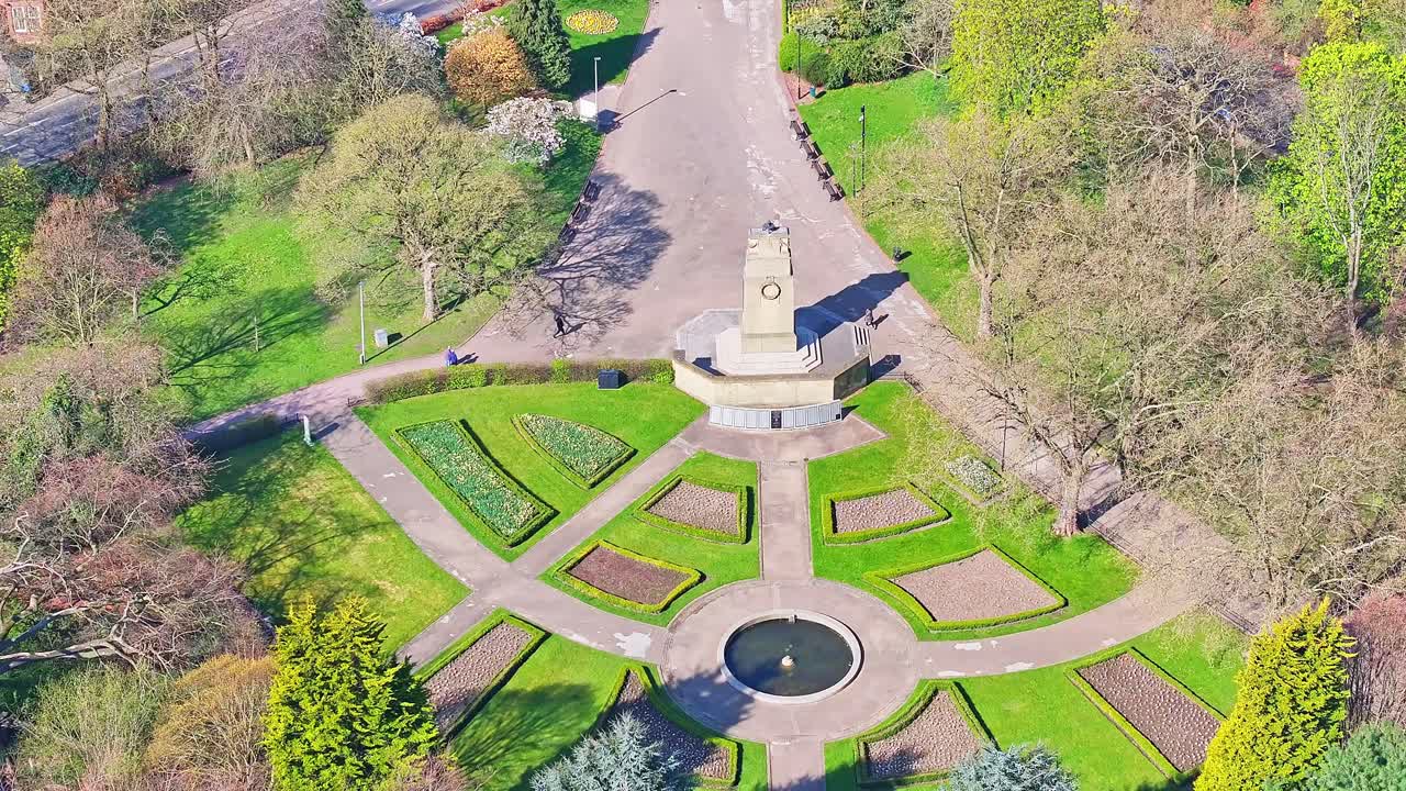 Neatly maintained Clifton city park monument with green zones, walkways and scattered trees from above