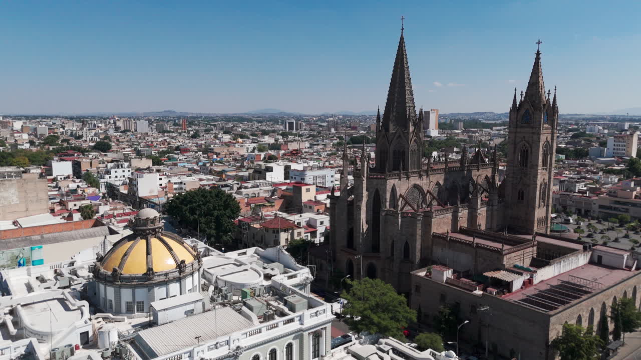 Aerial shot of the Expiatorio parish and the Museo de las Artes in Guadalajara, Jalisco, Mexico, with the traffic of the Vallarta avenue