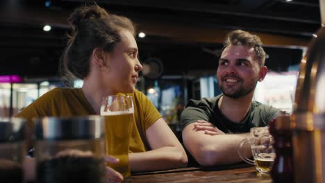 caucasian man and woman talking together in the bar.