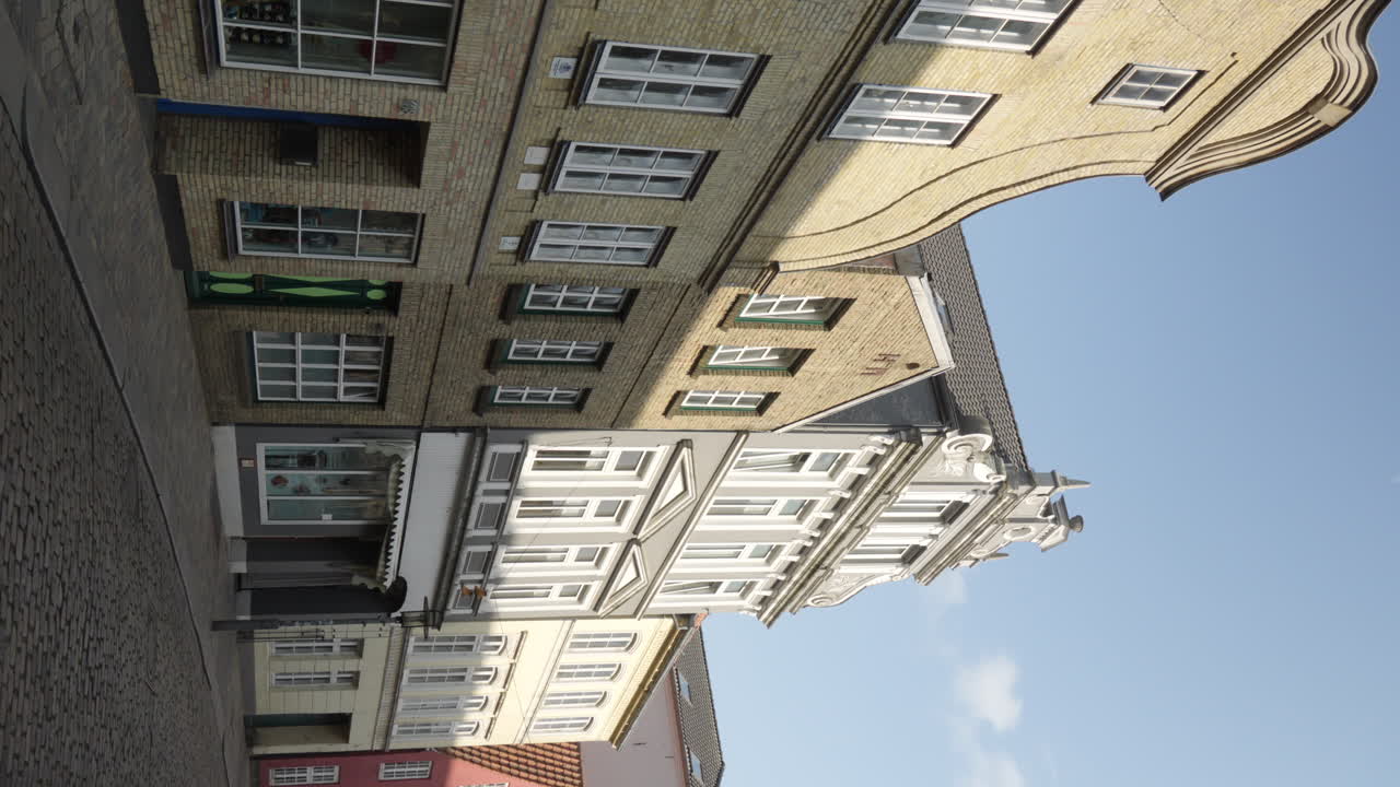 Quaint street in Flensburg, Germany with historic architecture. Vertical format ideal for travel scenes.