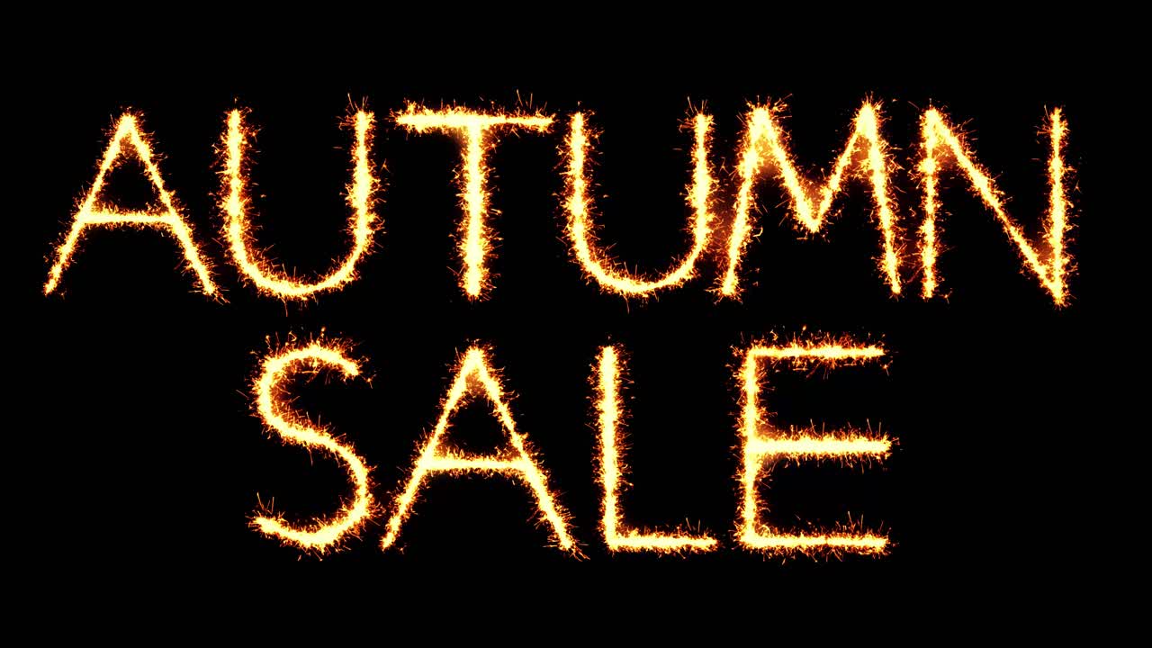Autumn sale text sparkler writing with glitter sparks particles firework on black 4k loop background