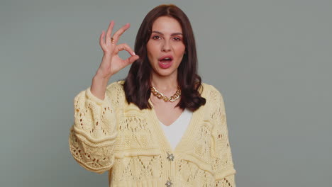 woman smiling and giving okay sign