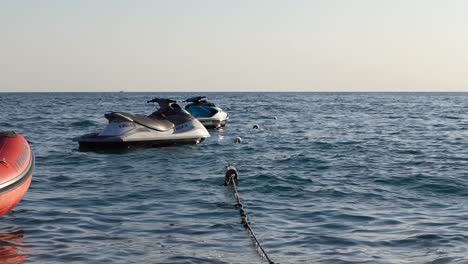 static shot of jet ski parked in the water in sunset