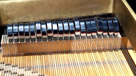 piano hammers, mechanic hammers and strings inside old piano, piano hammer mechanism