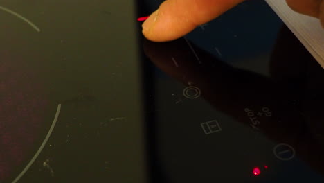 Finger touch and turn on electric hotplates in kitchen