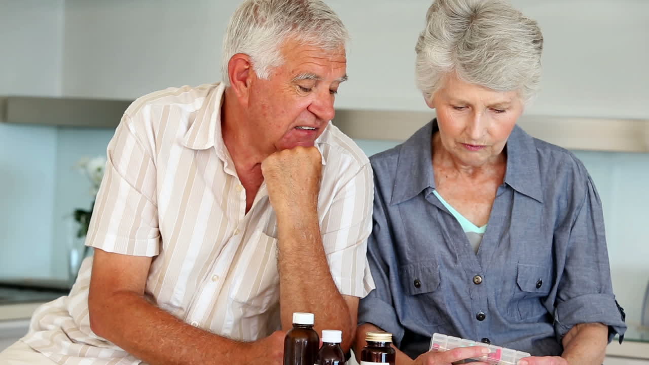 Senior couple organizing their medicine for the week