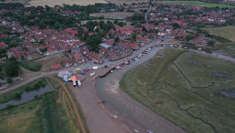 Aerial-footage-moving-towards-Blakeney-Quay-in-Norfolk,-England-at-sunrise