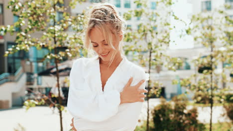 smiling woman in white shirt outdoors