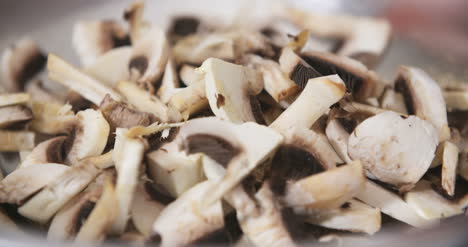 chef slicing mushrooms in kitchen 3