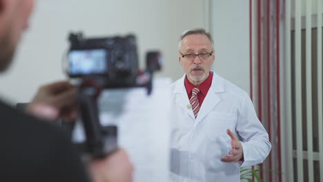 live webinar. professional male doctor wear white uniform consulting online. medical specialist doing video conference looking at camera. electronic medical appointment concept.