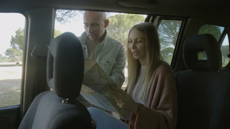 happy young couple discussing map