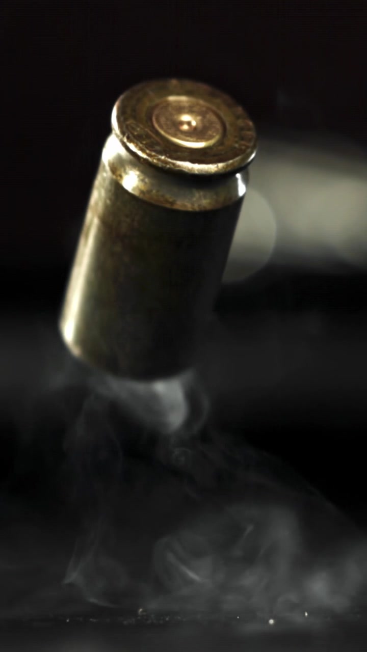Slow Motion of a Brass Bullet Casing Falling with Smoke