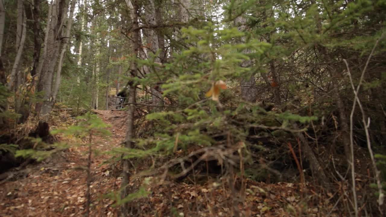Biker rides pass the camera pan