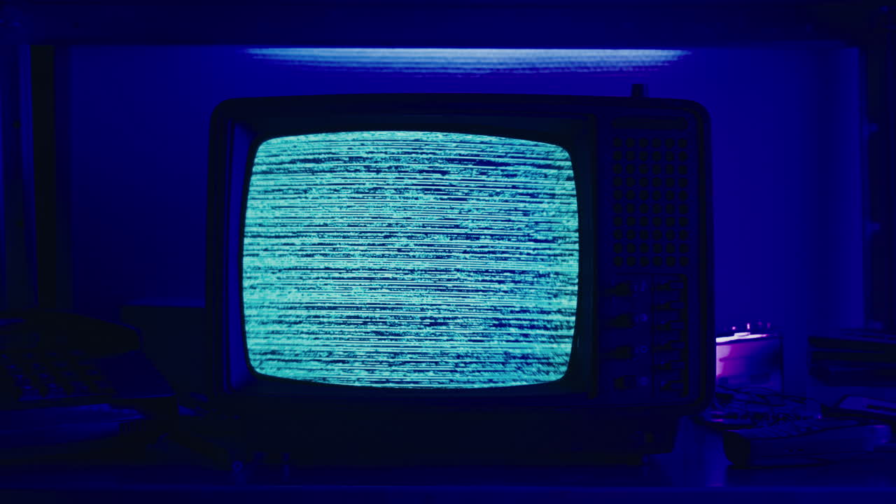 Retro TV, vintage television In a nostalgic setup, a retro TV displays grain on screen, scary halloween night device good for chroma key and green screen.