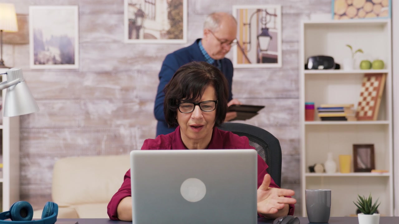 Mature Woman Working on Laptop in Home Office