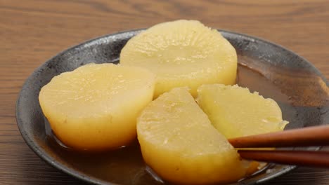 divide the oden radish into two equal parts with chopsticks