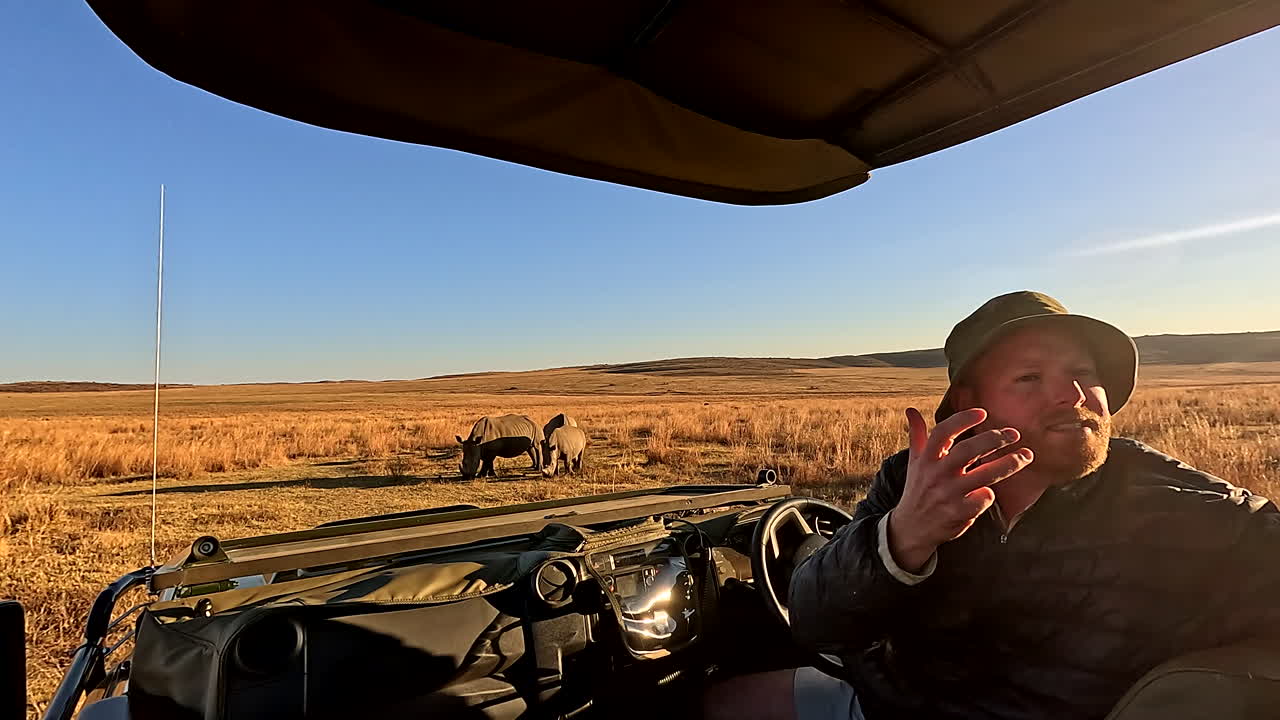 Field guide shares knowledge to guests about rhinos on African morning safari