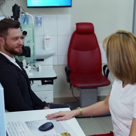 ophthalmologist checking eyesight of man