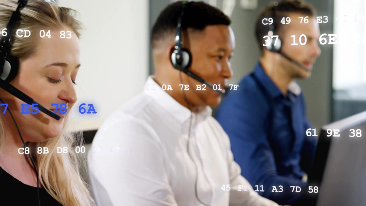 Cam panning left revealing woman, agents speaking into mic and typing hex overlay mapping support