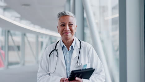 Doctor,-walking-and-a-woman-greeting-in-a-hospital