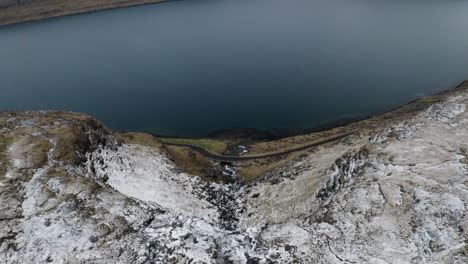 faroe islands, 4k aeria wide and tilt down to reveal beautiful fossá waterfall