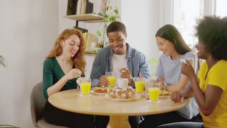 diverse friends enjoying a lively breakfast together at home