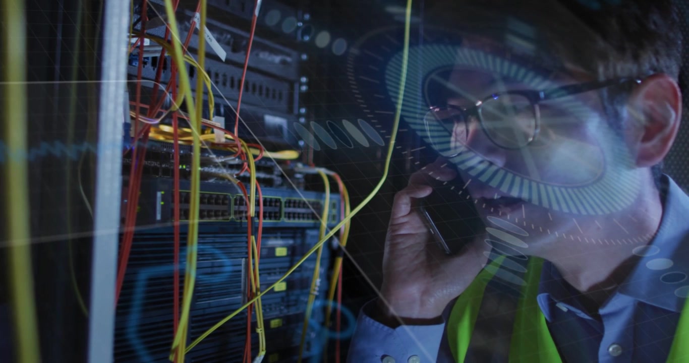 Male tech taking call, inspecting rack in datacenter while HUD overlay pulsing, relaying fixes