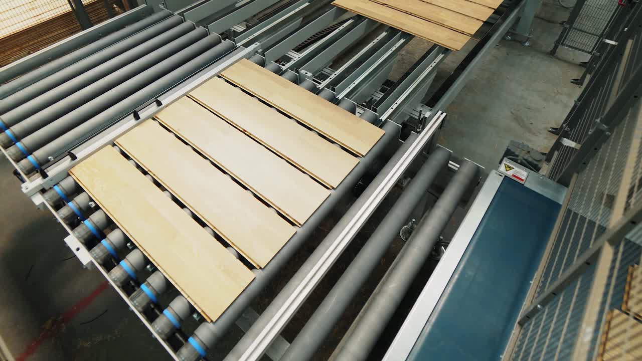 Floorboard production in the industrial factory. Manufacturing of a parquet board. Modern technologies.