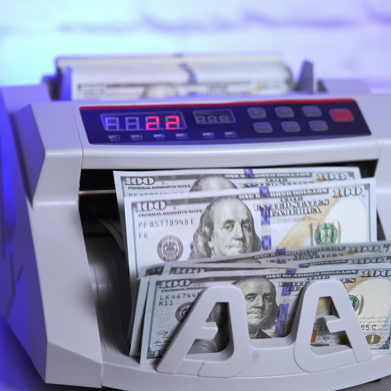 Electronic equipment for financial operations in bank. Woman's hand putting paper money into a counting machine