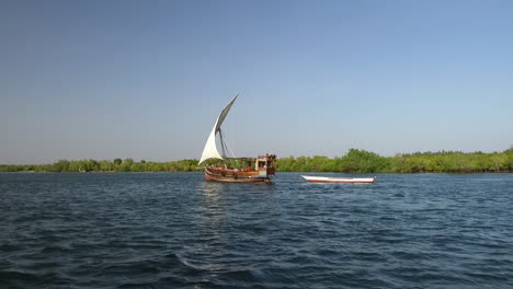 a swahili dhow boat sails on mida creek in watamu, kenya.