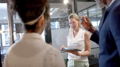 Vertical-video-of-diverse-business-people-discussing-in-office-with-copy-space