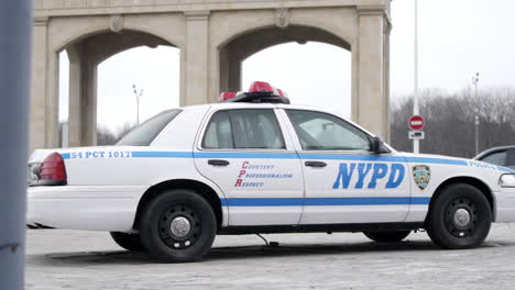nypd police car in front of archway
