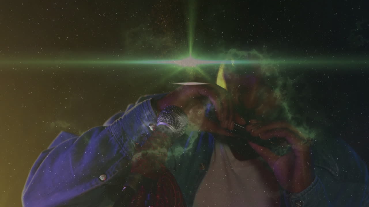 male musician playing harmonica on music stage, showcasing cosmic nebula and color lights