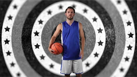 portrait of caucasian male basketball player holding a ball against stars on spinning circles