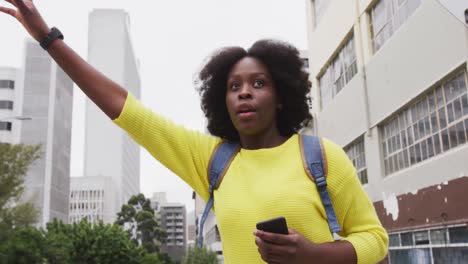 African-american-raising-her-hand-in-street