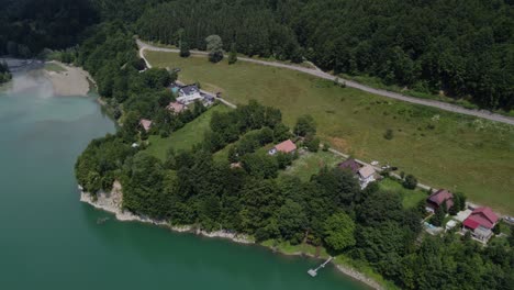 Aerial-orbit-shot-of-traditional-village-in-a-healthy-ecosystem-of-lakes-and-forests-in-Paltinu-of-Doftana-Valley-in-Romania