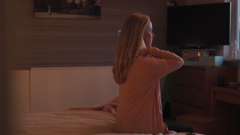 woman stretching in bedroom