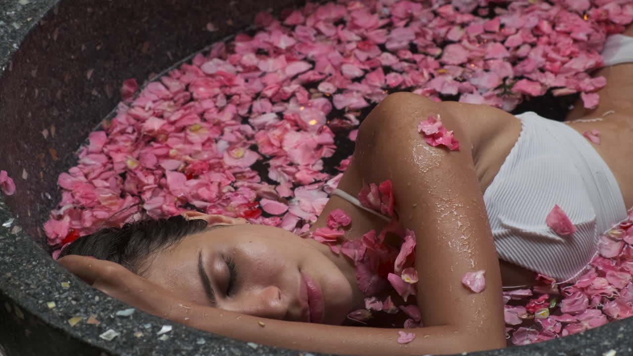 Woman Relaxing in a Rose Petal Spa Bath
