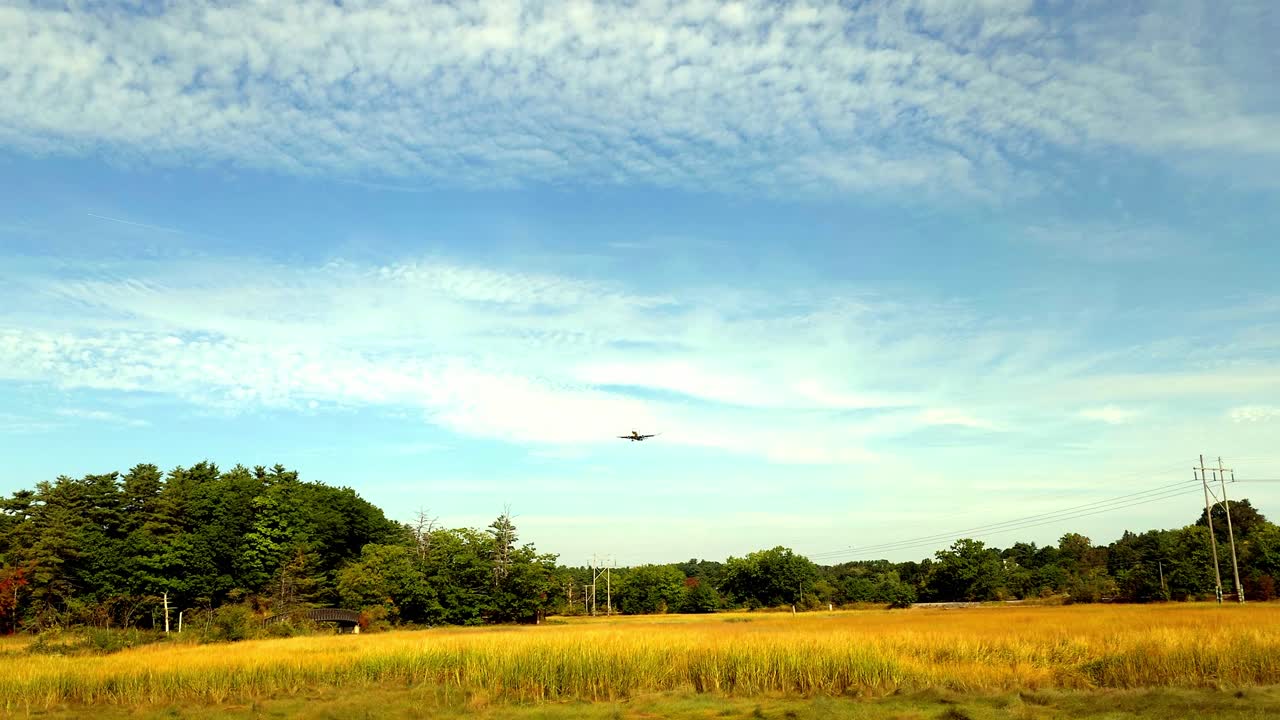 Passenger plane crossing Fore River Sanctuary in Portland, Maine