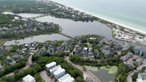 back up motion wide full view of cramp creek lake, with community around it , active transit and ocean in the background right