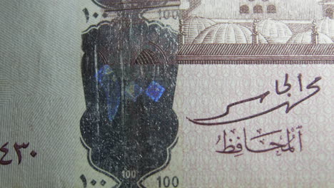 this is the macro view of a normal paper bank not- money- currency ofsaudi arabia 100 riyals bill