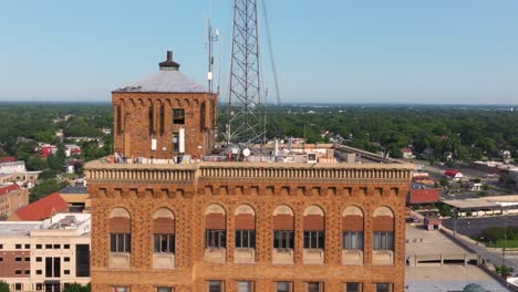 Drone Descends to Reveal Brick Skyscraper in American City. Aurora, Illinois