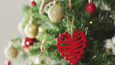 closeup of christmas balls and decorations on the green christmas tree