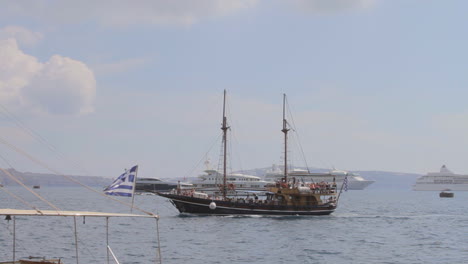 a tourist boat approaches a small sea port in a greek island