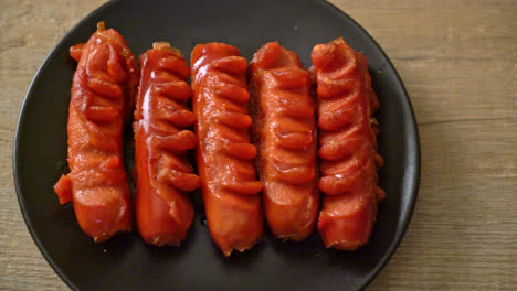 deep-fried-sausage-skewer-on-black-plate